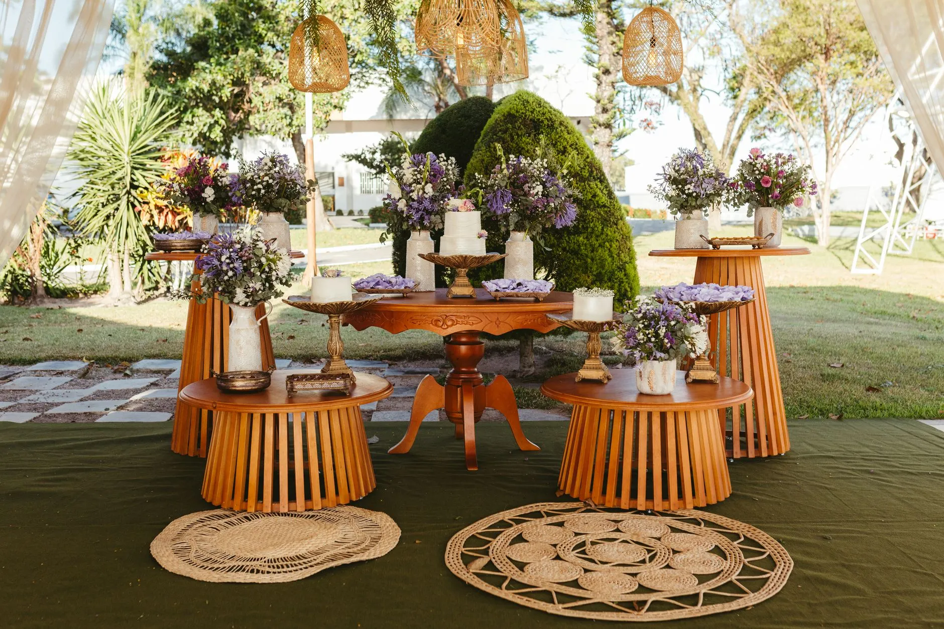 a grazing table decorated with flowers in a garden setting