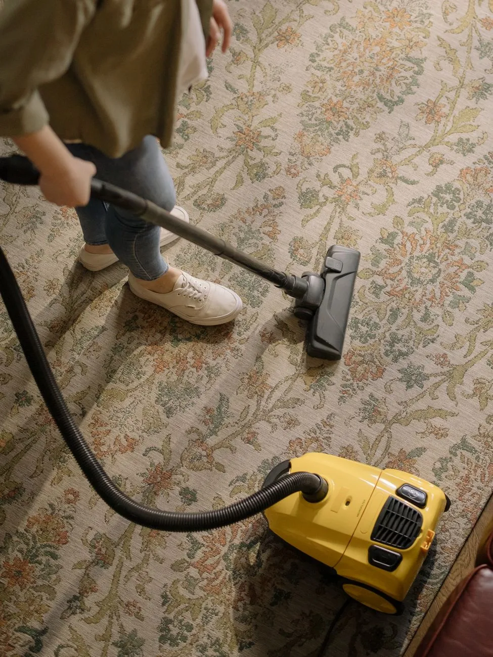 vacuum cleaning a patterned living-room carpet