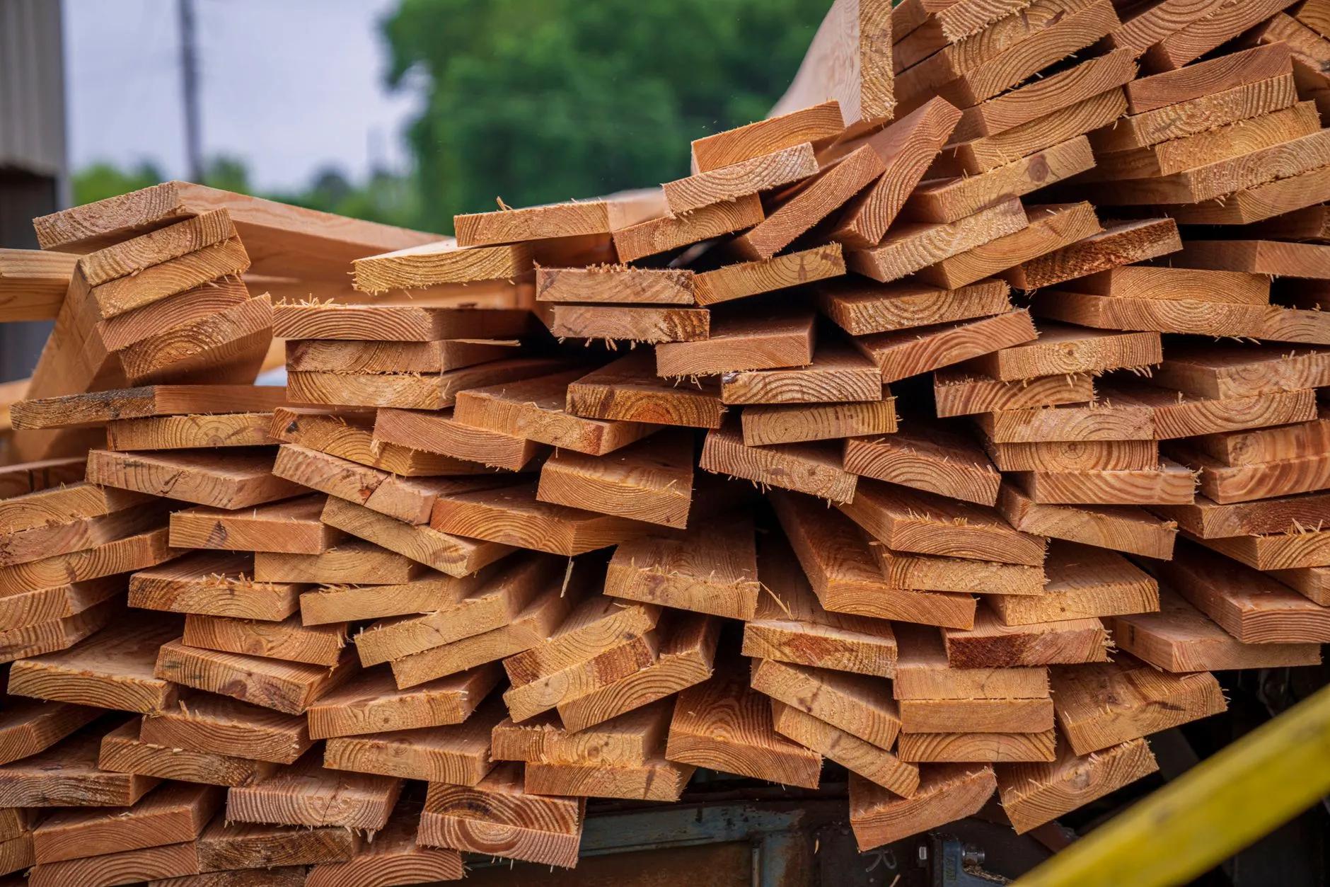 A stack of freshly cut pressure-treated timber boards