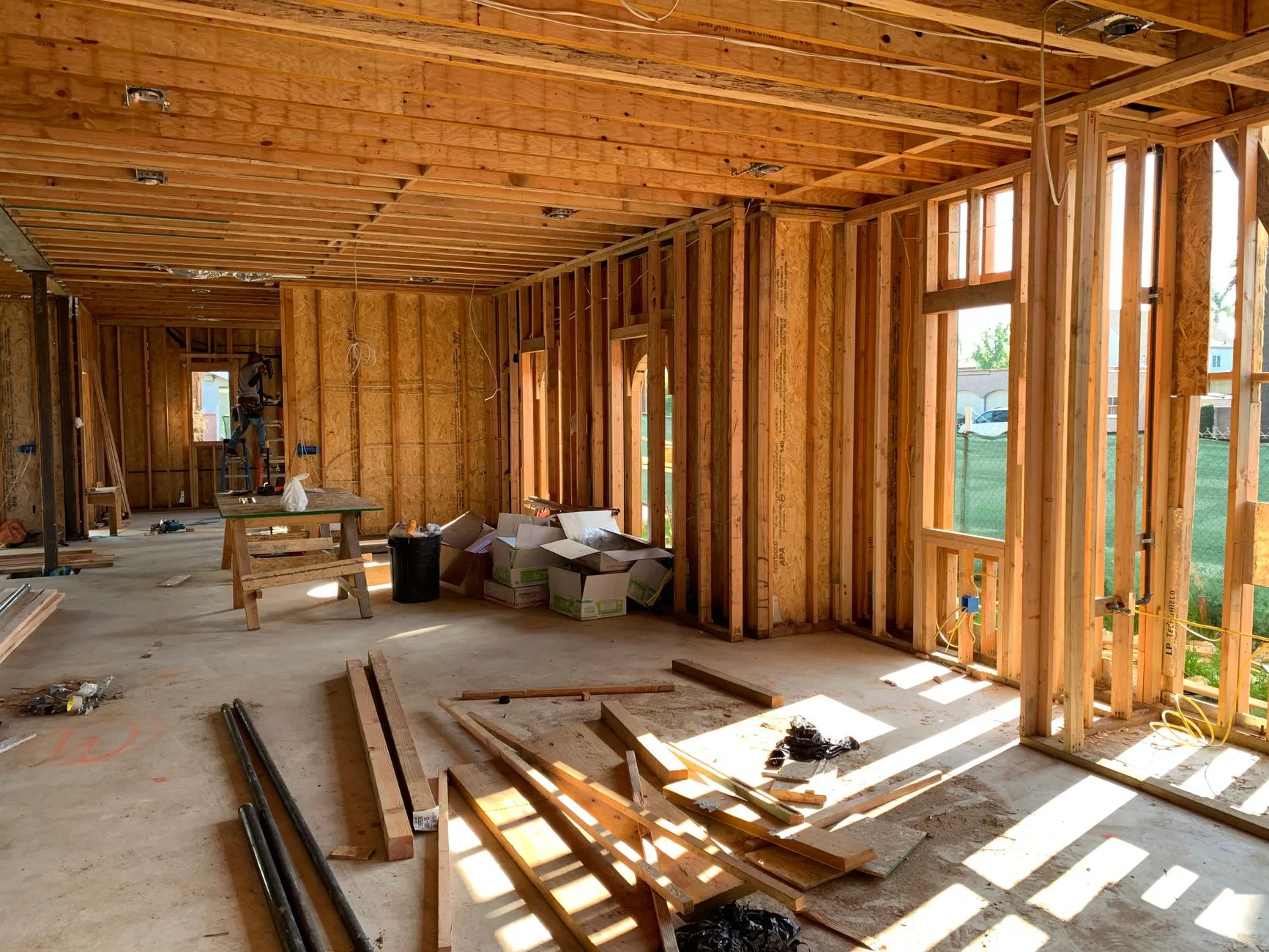 the interior of a framed house showing stud walls, ceiling joists and window openings