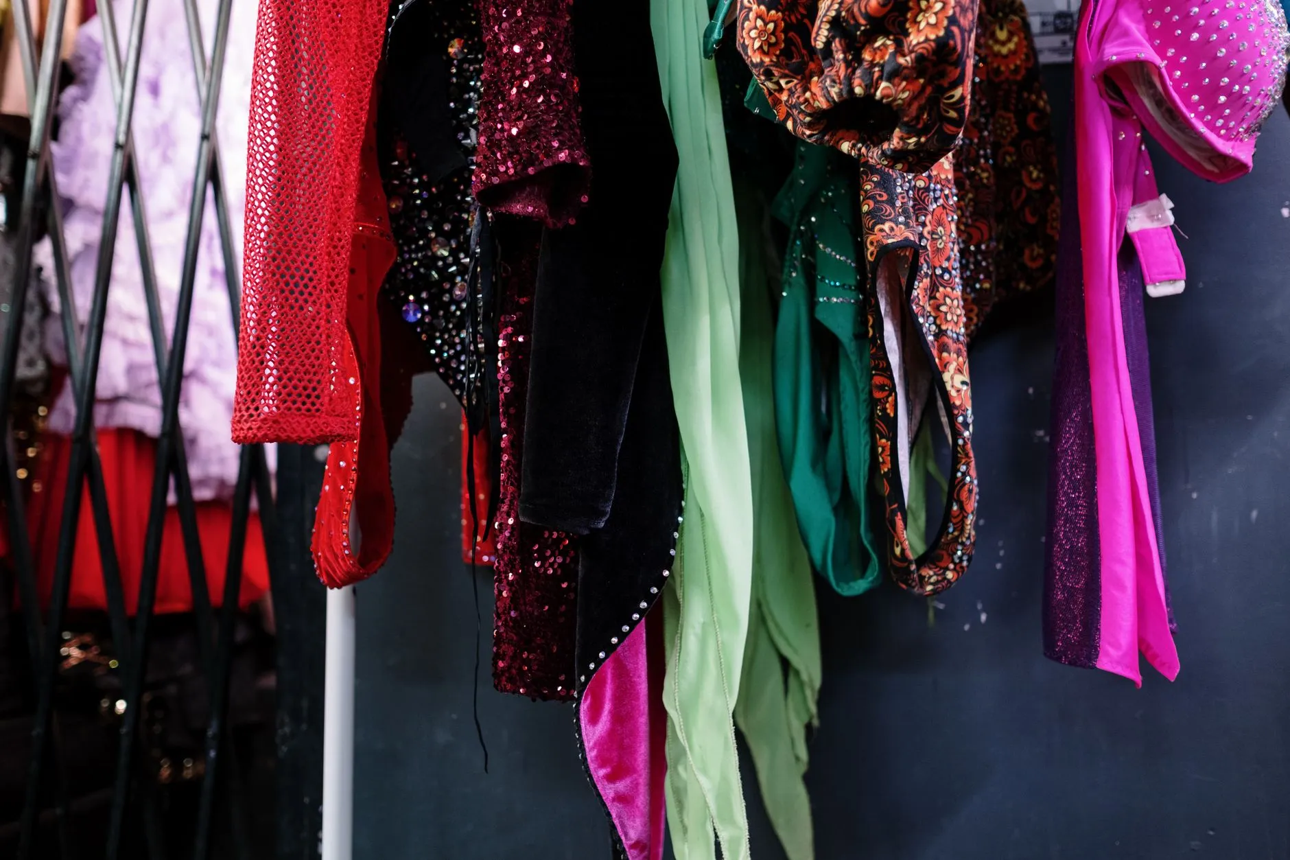 sequined costumes hanging on a rack