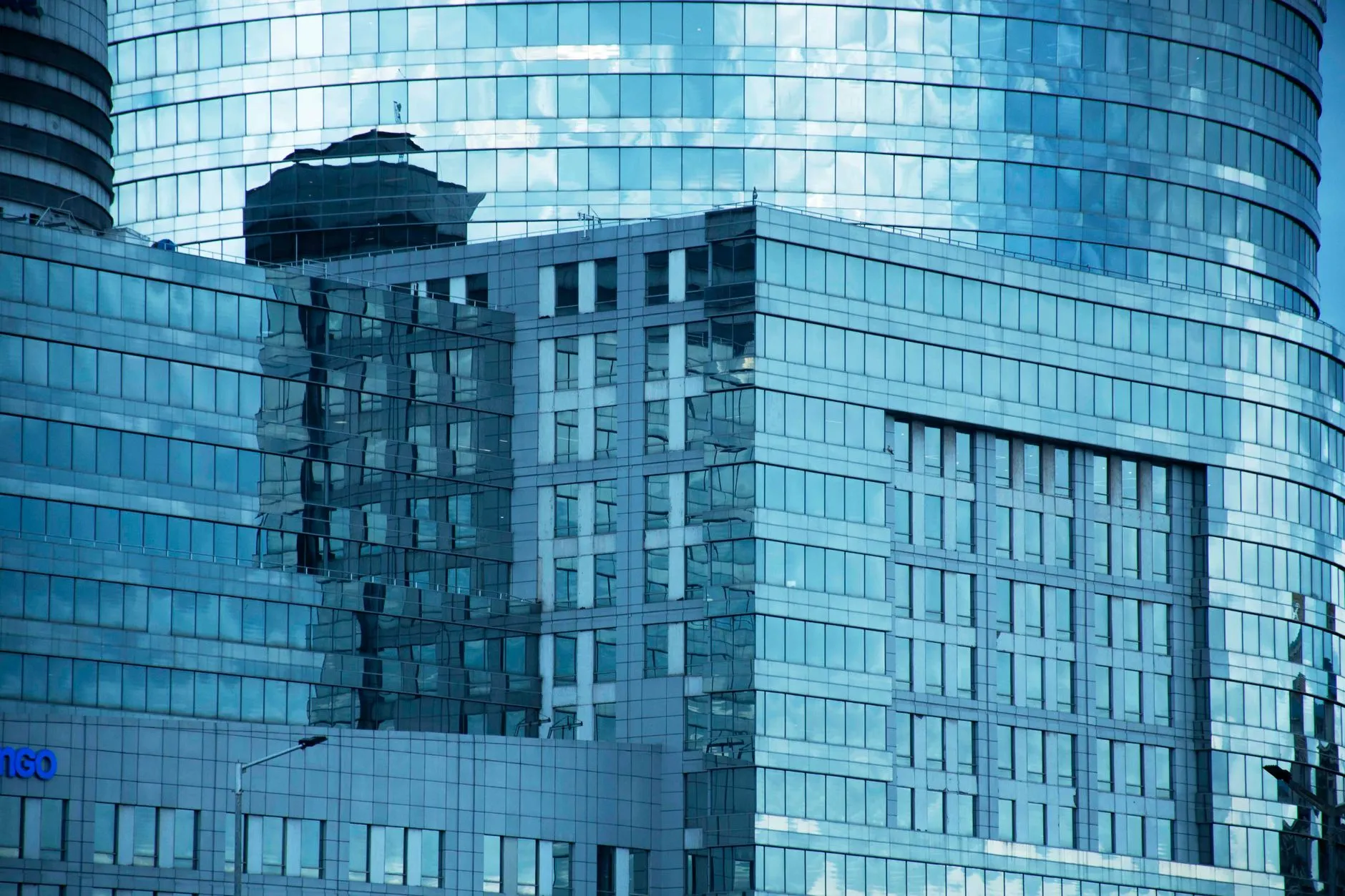 a glass curtain wall office tower against the sky