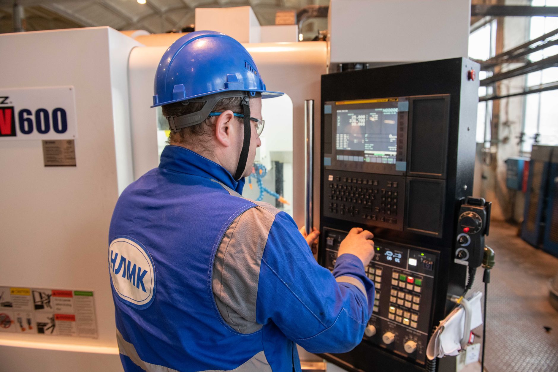 a worker operating a CNC machine