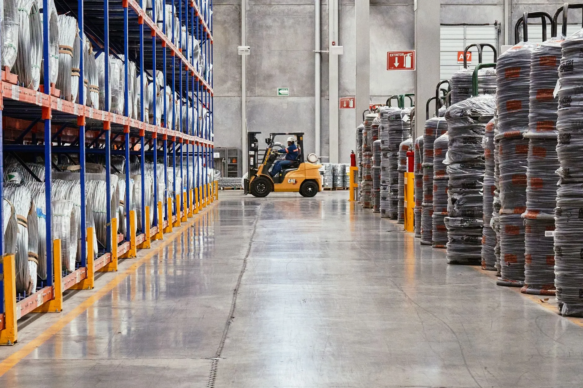 a forklift moving pallets in a warehouse