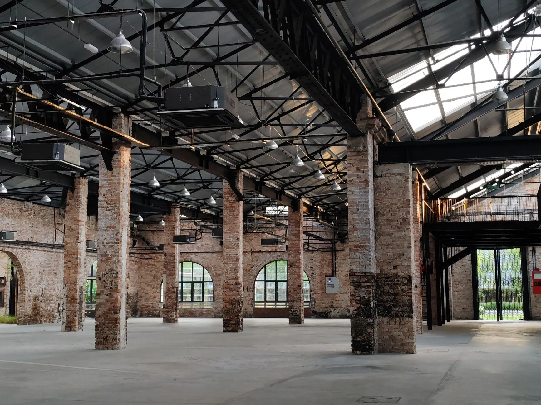 a renovated brick industrial hall with steel columns