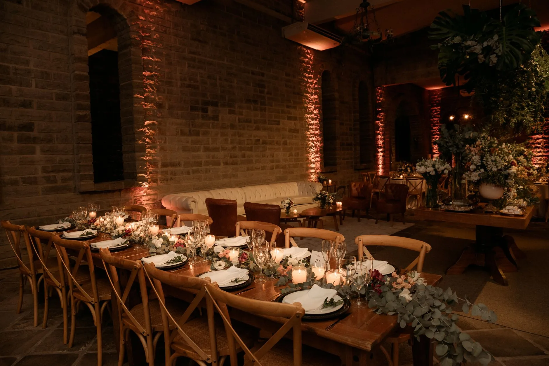 a wedding reception room lit with warm layered lighting