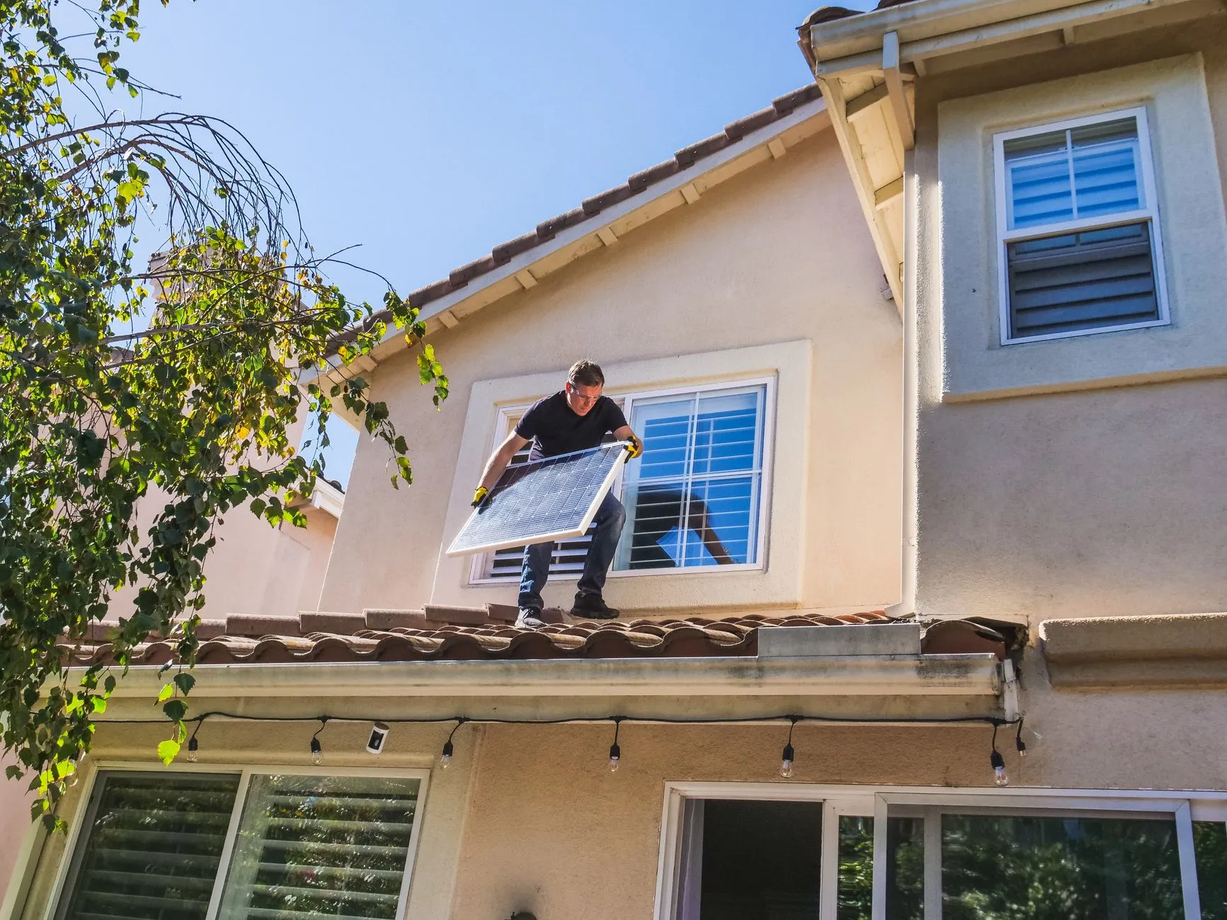 a person installing gutter guards on a roof edge