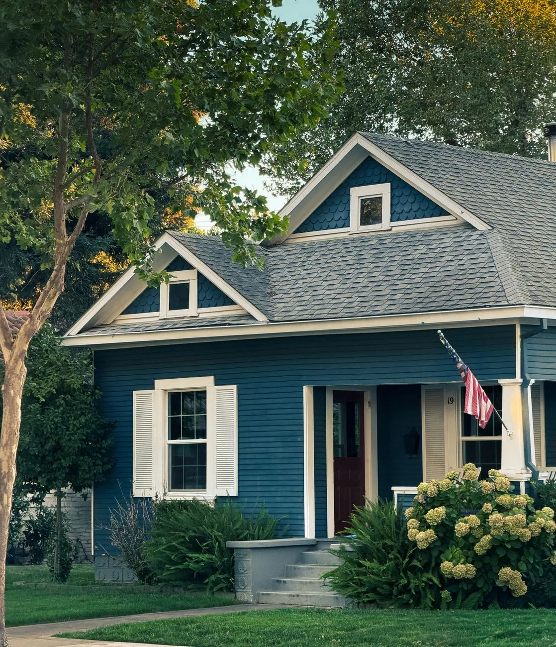 a well maintained bright suburban home exterior with a tidy yard