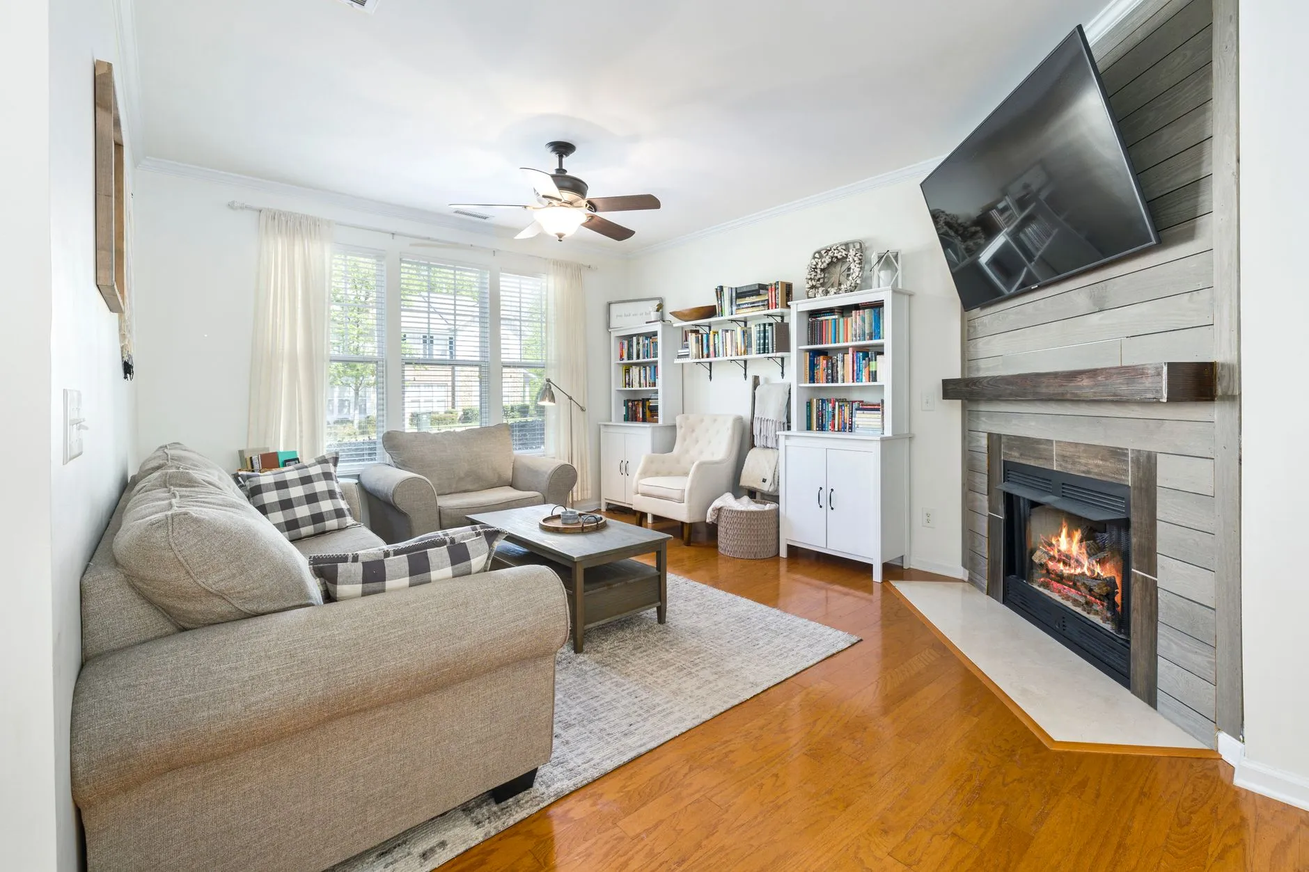 a flat screen tv mounted above a fireplace with no visible wires