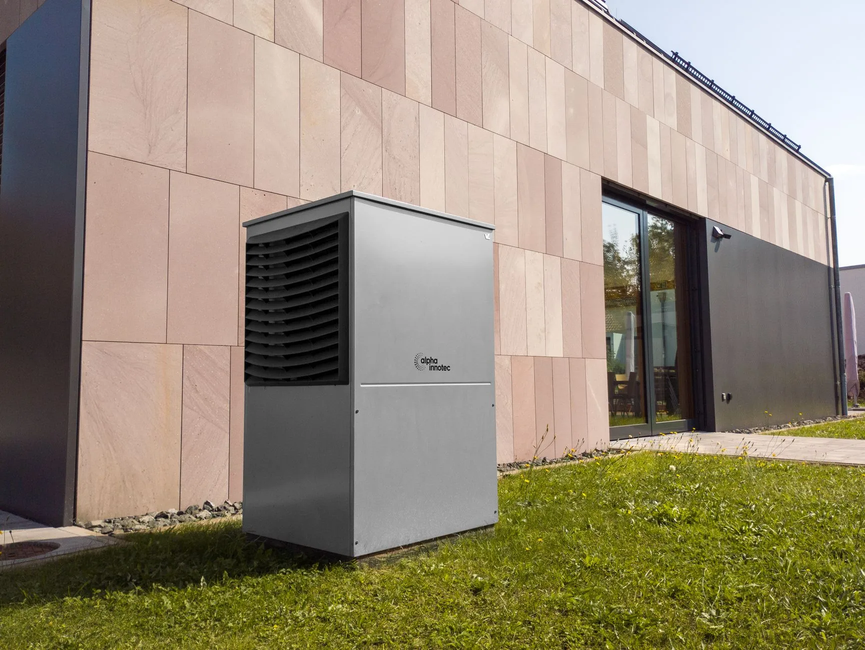 New high-efficiency AC condenser unit installed beside a modern home