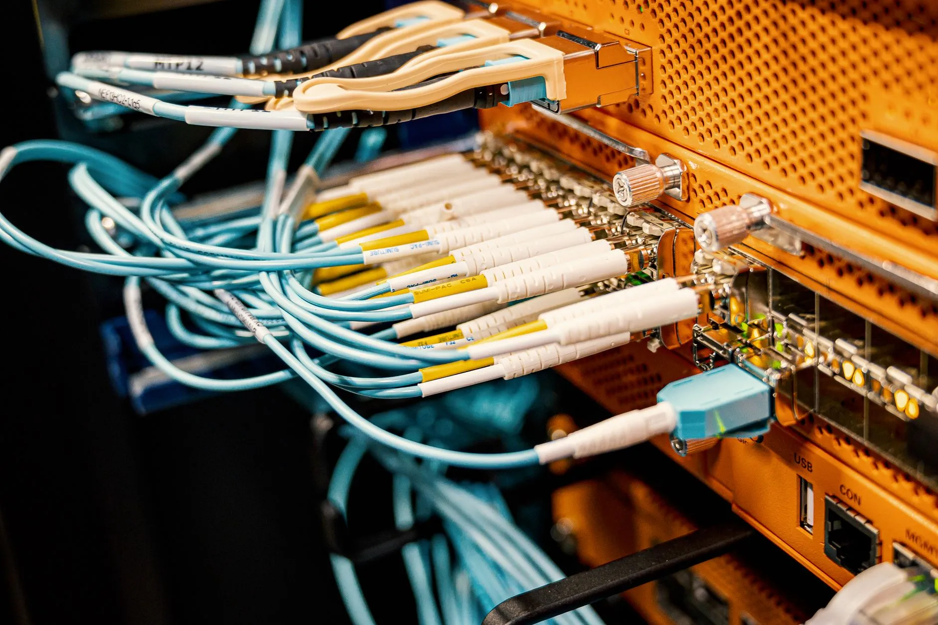 fiber patch cords plugged into network hardware