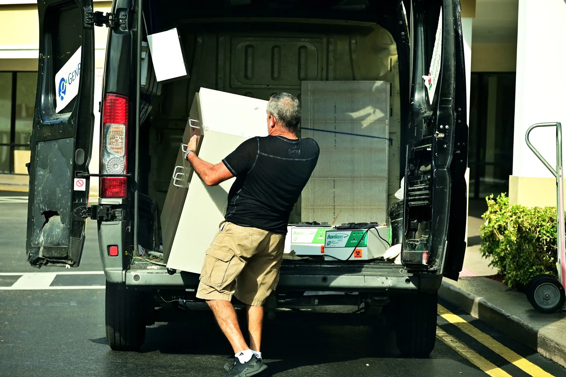 junk removal truck loaded outside a home