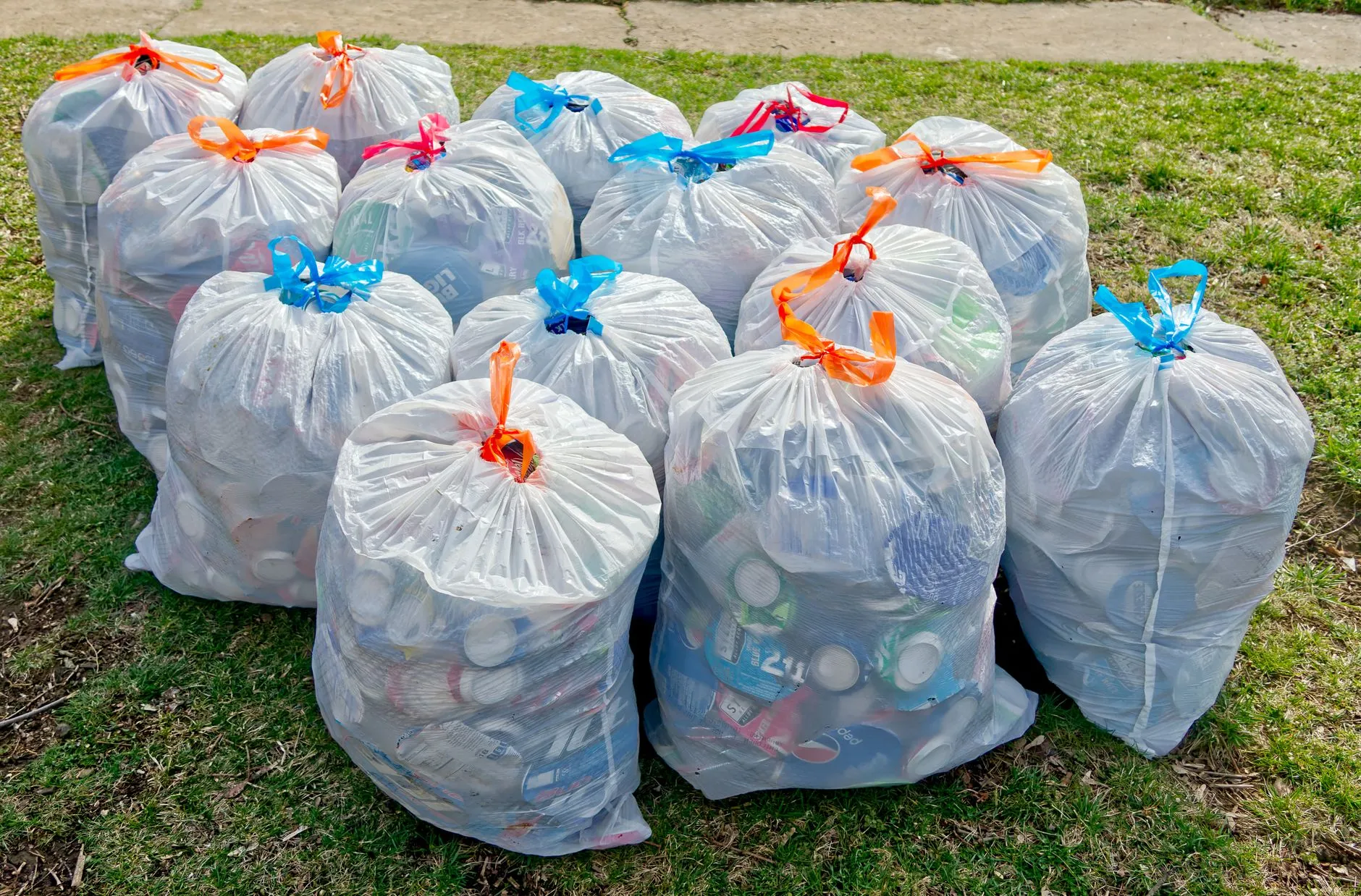 tied bags of collected litter on the grass