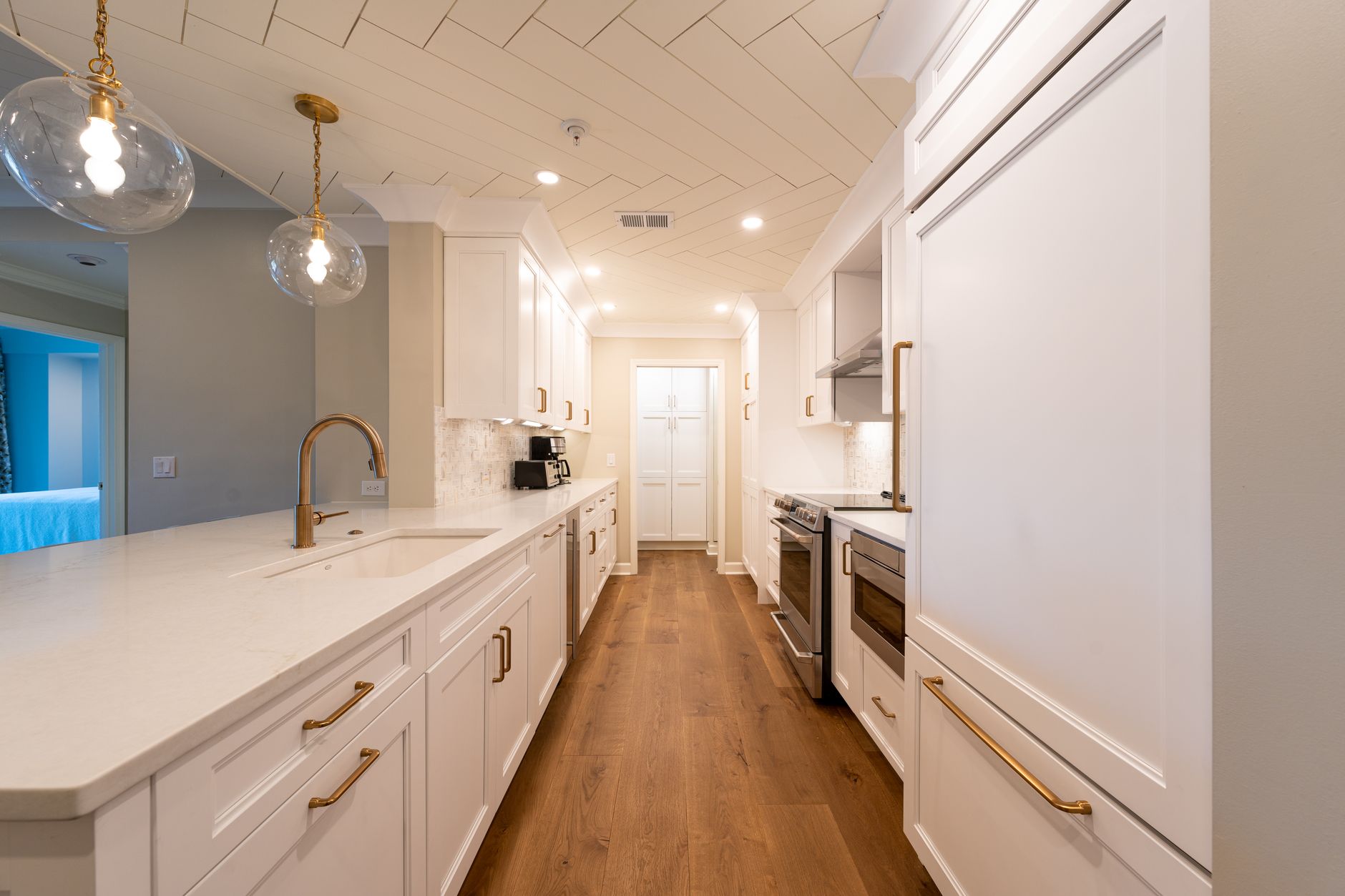 bright refinished white kitchen with an island and gold hardware