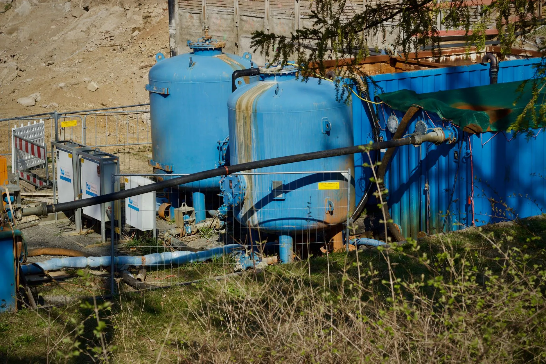 Hydro jetting nozzle spraying high pressure water into a pipe