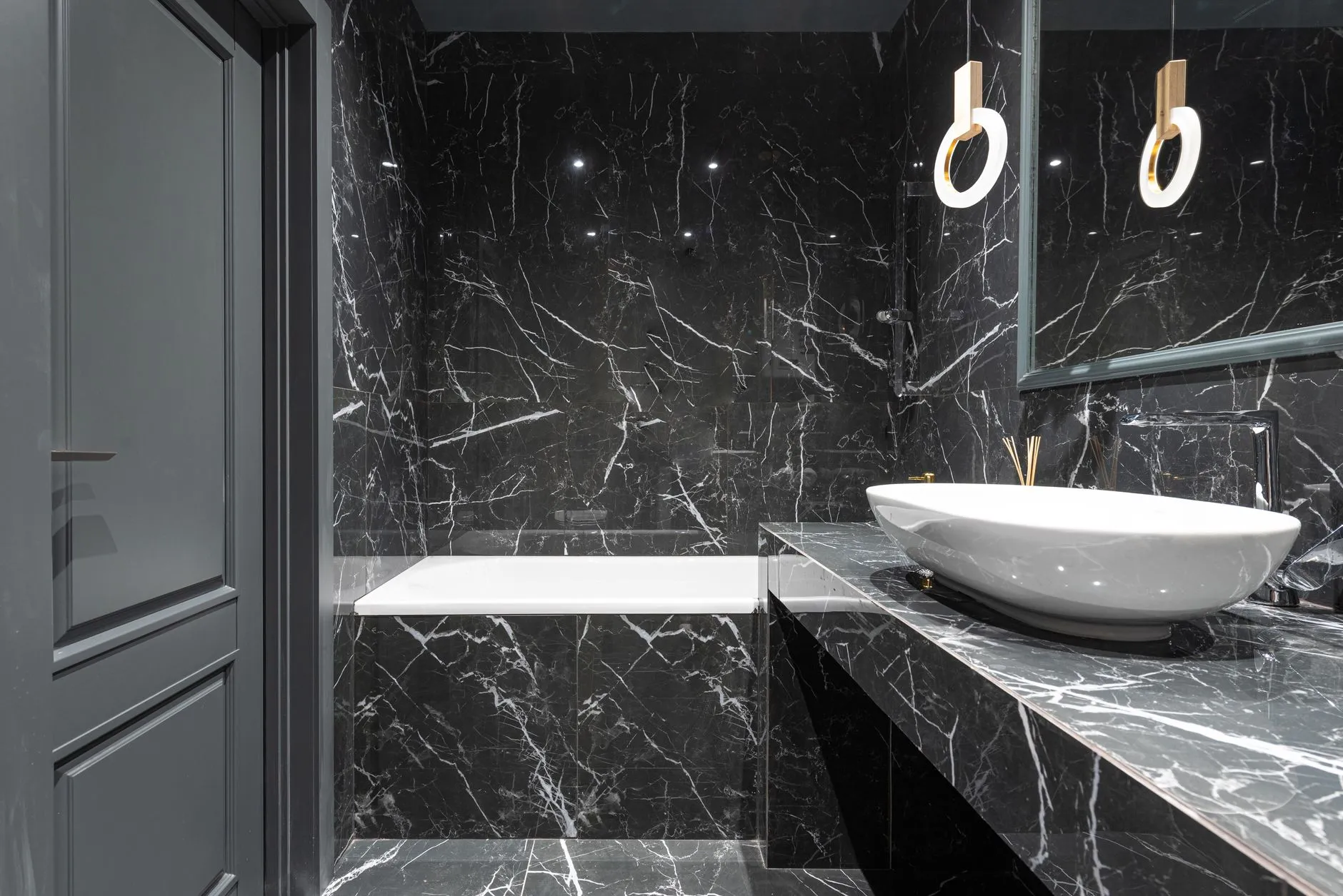 Dark moody luxury bathroom with dramatic lighting