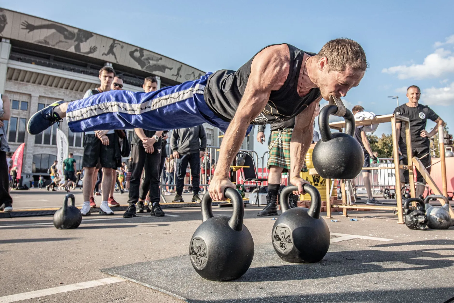 people doing a kettlebell workout outdoors in a group