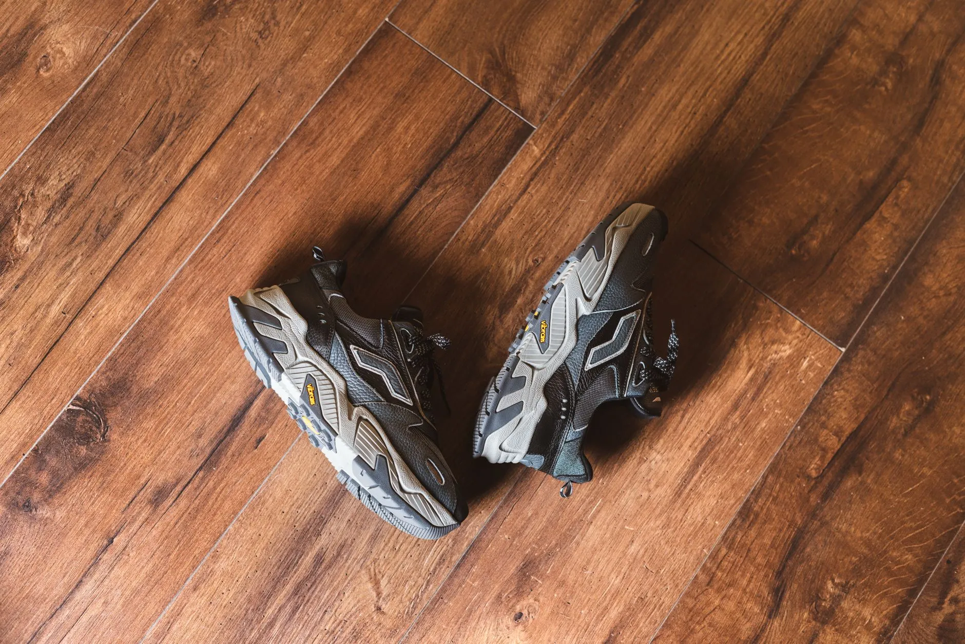 a pair of supportive walking shoes on a wooden floor