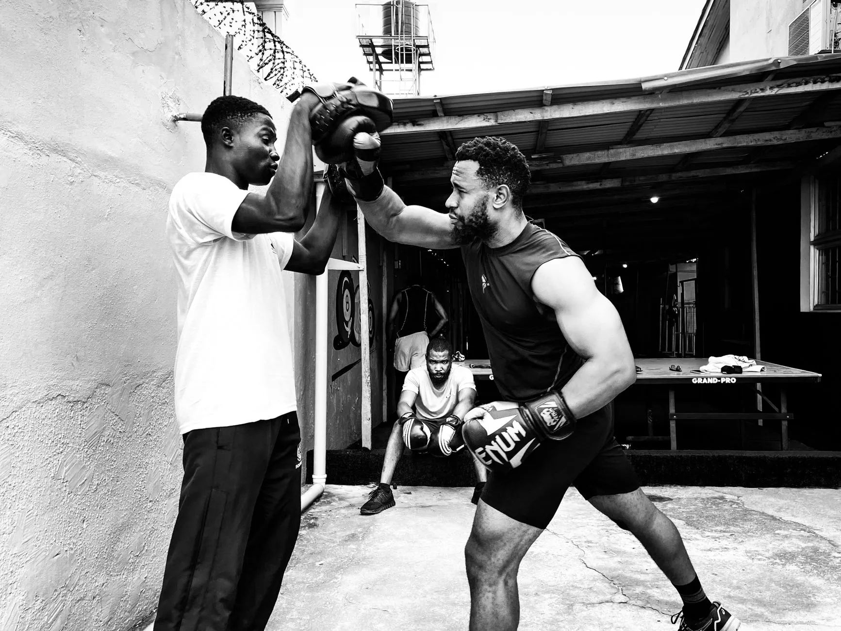 a coach guiding a client through a movement drill