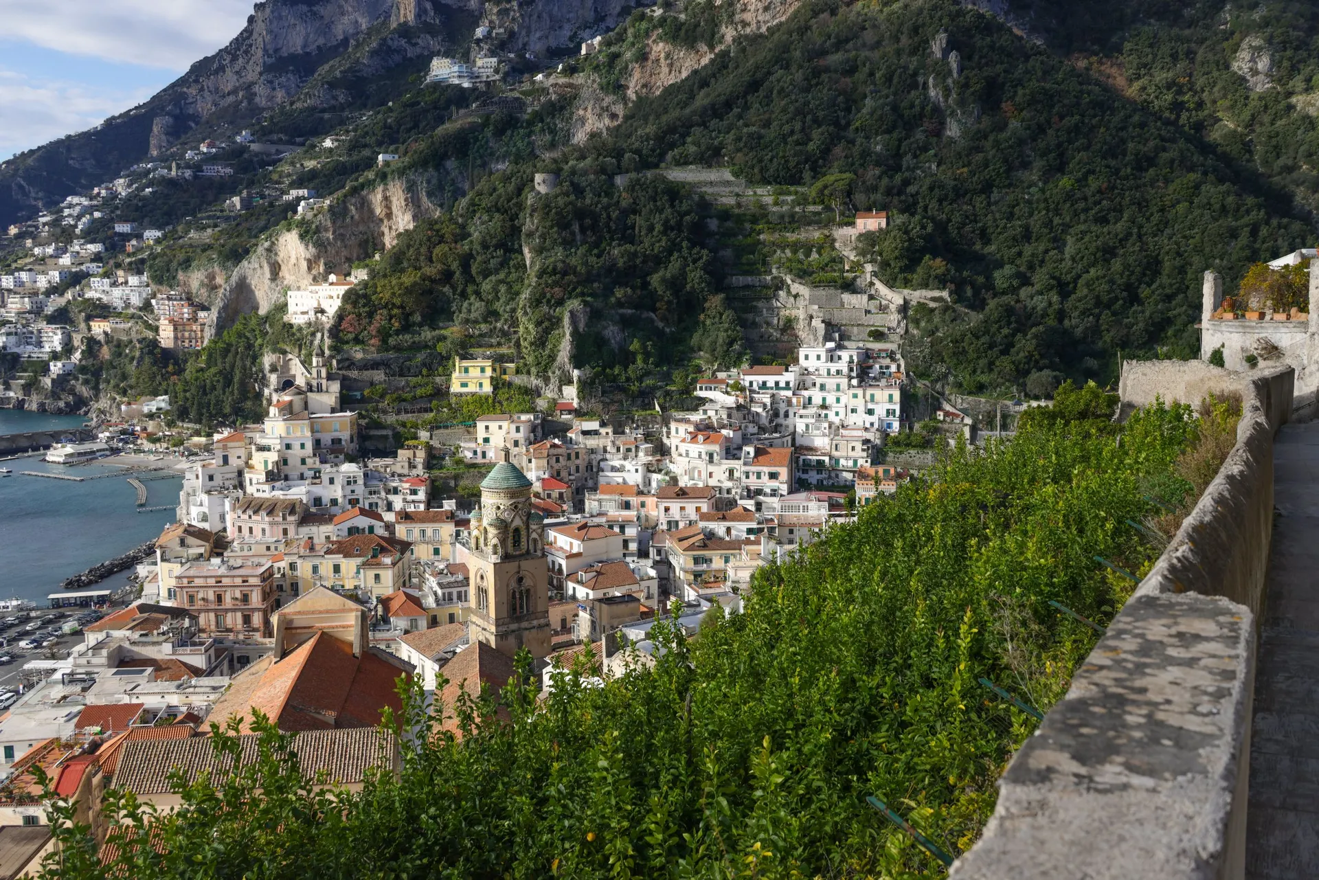 pastel village on a green cliffside above the sea on the Amalfi Coast