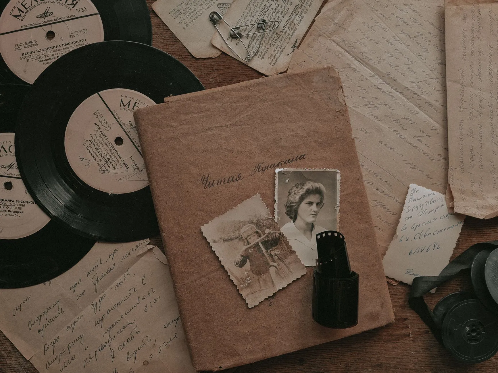 sepia photographs, letters and a record on a table