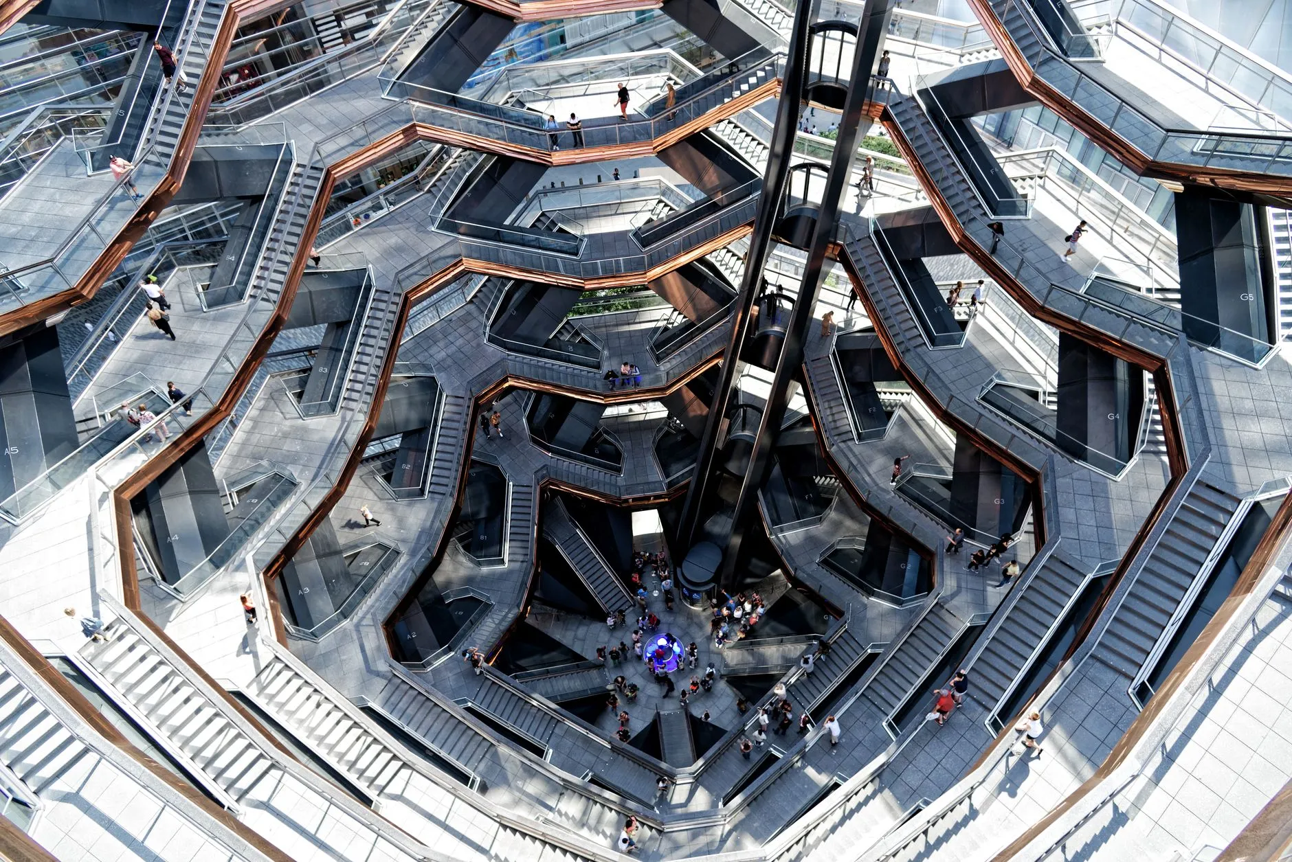 looking up through a sculptural dark steel staircase