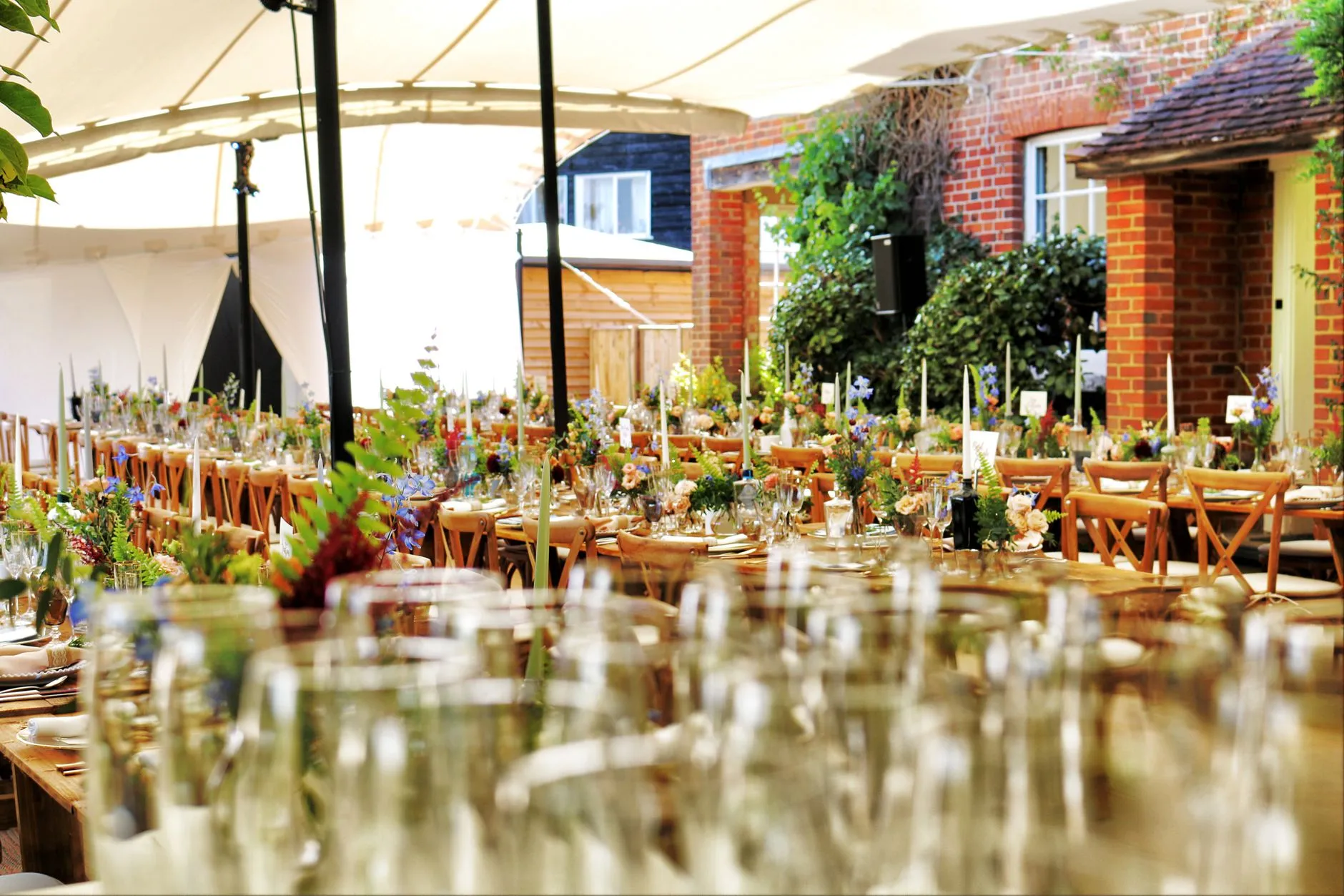 long farm table wedding dinner with wildflowers and candles