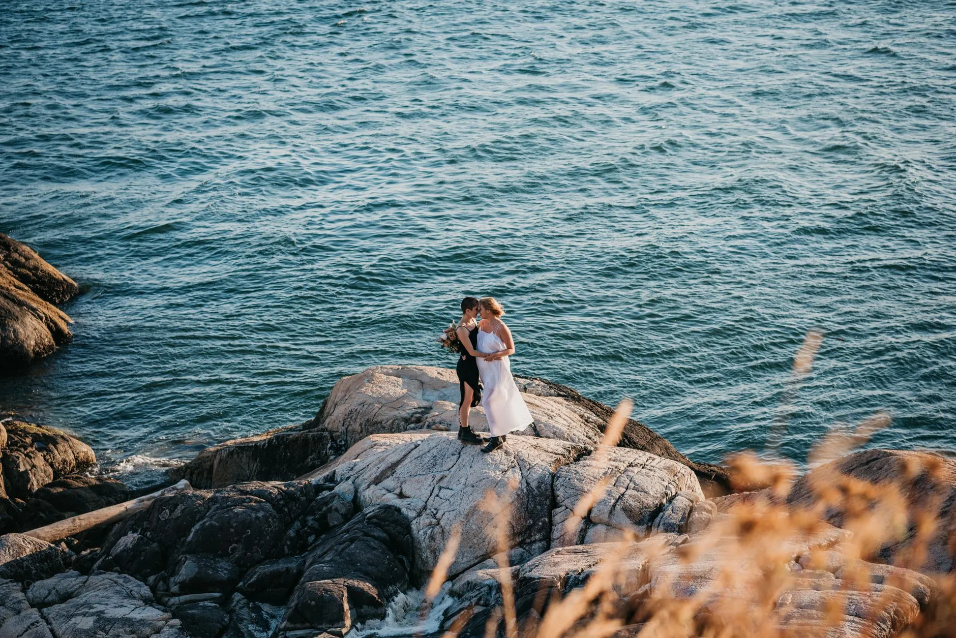 couple eloping on a misty Oregon coast cliff at sunrise
