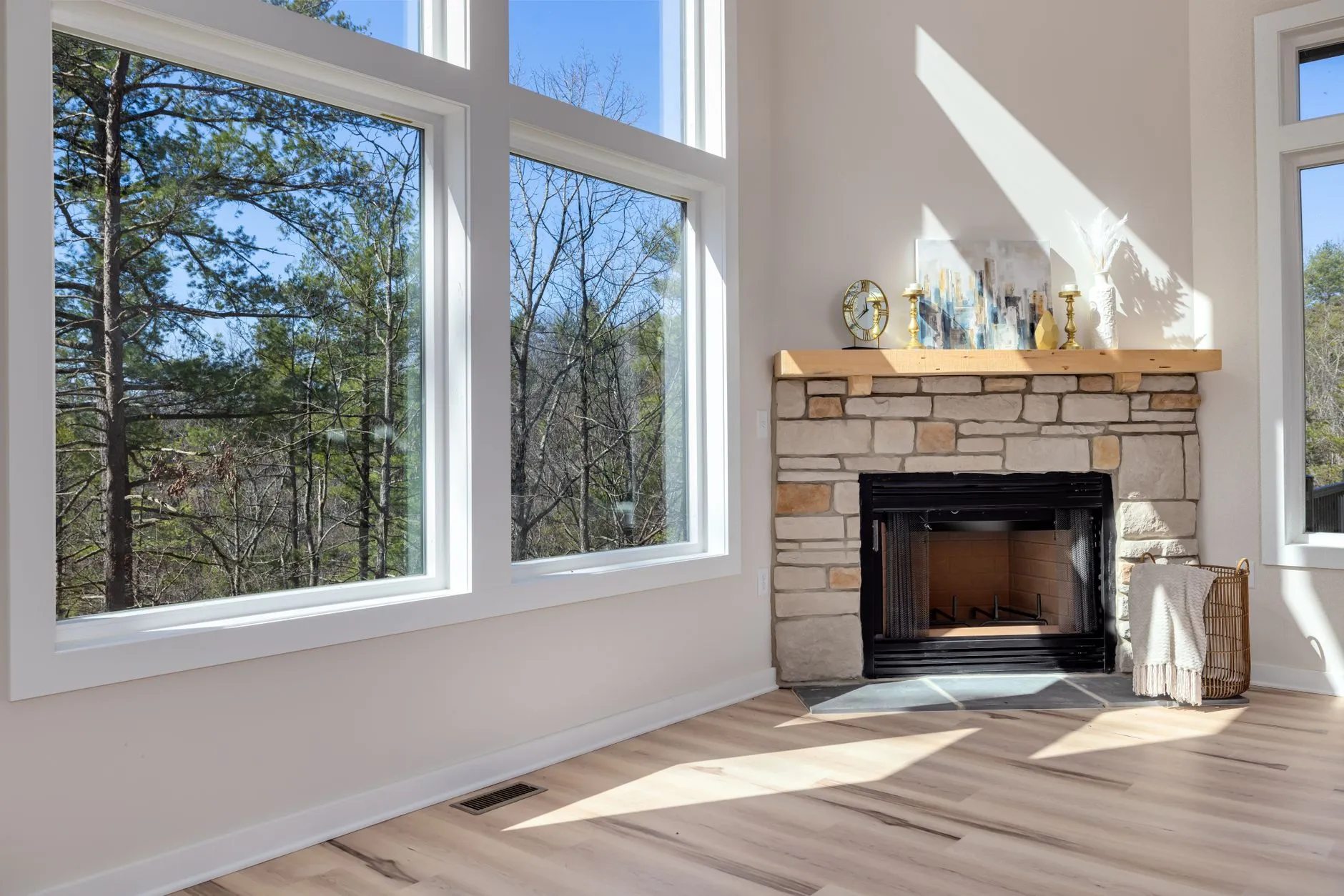 an elegant mountain lodge wedding venue interior with a stone fireplace and large windows