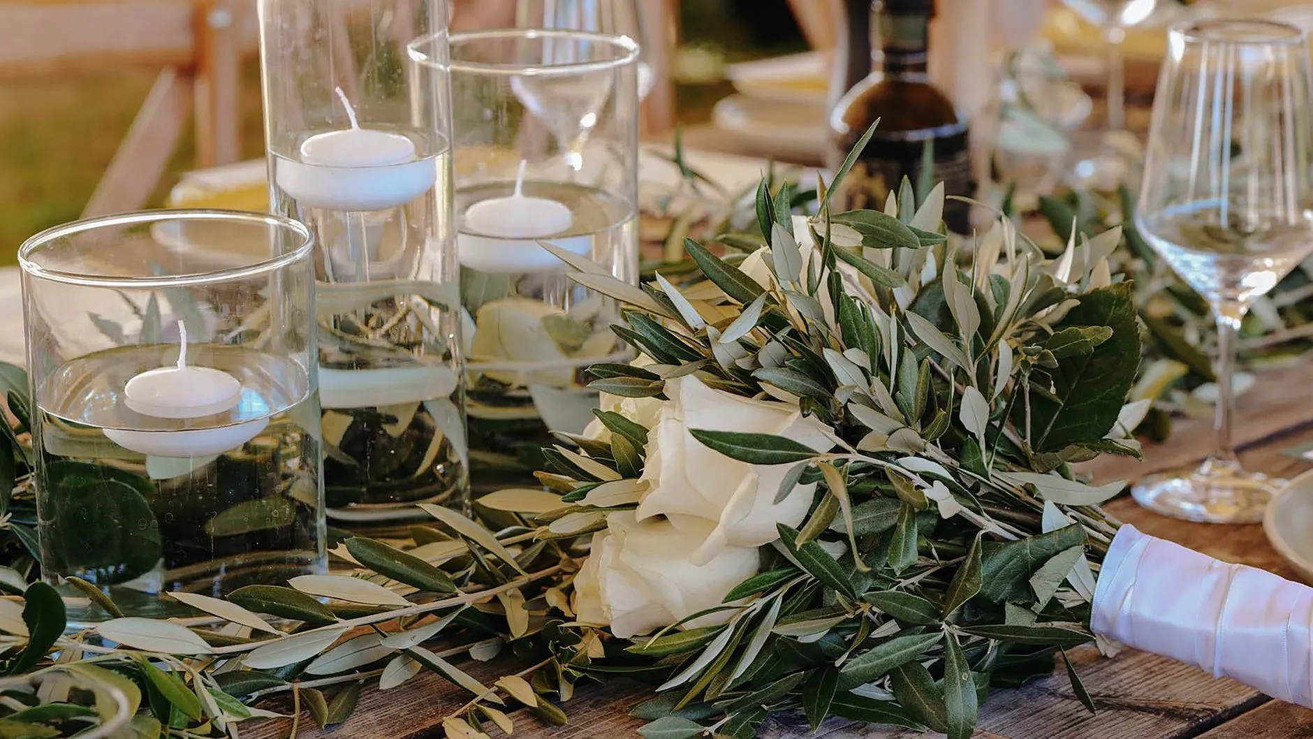 rustic wine country wedding tablescape with grapes olives and greenery