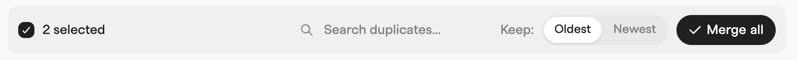 Duplicates merge toolbar with two groups selected, a Keep oldest or newest choice and an active Merge all button