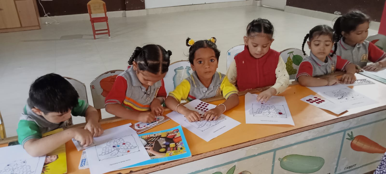 Activity on Bindi pasting  done by nursery kids